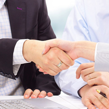 A colour picture of people shaking hands, as a metaphor for the residential property solutions of Oakford Group